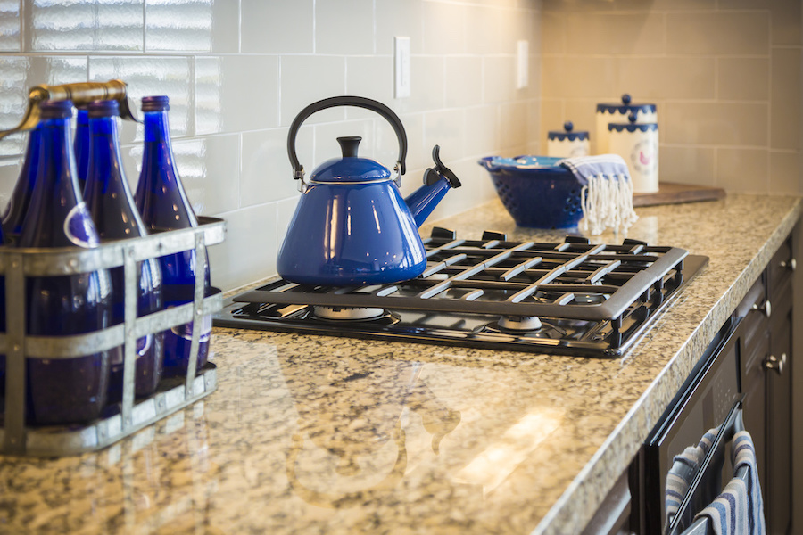 Bautiful Marble Kitchen Counter and Stove With Cobalt Blue Decor.