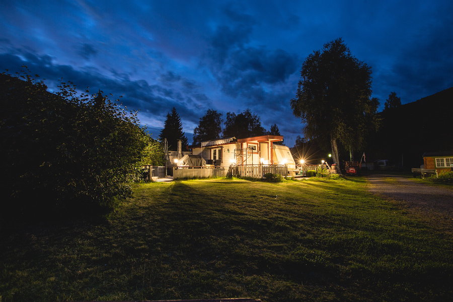 Norway camp house in the summer night. Blue sky. Adventure trip to norway.