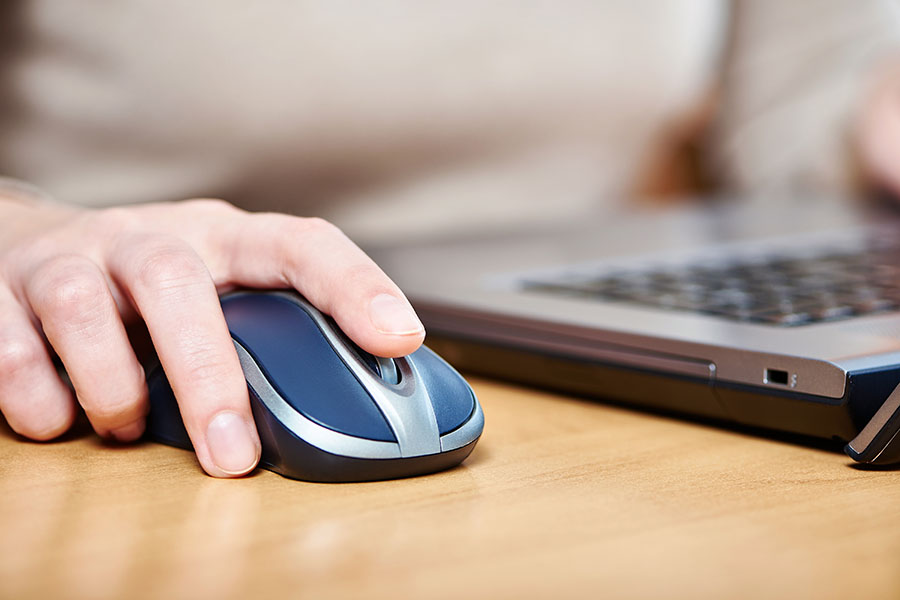 Female hand touching computer mouse closeup